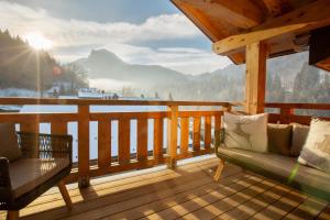 a porch with a bench and a view of the mountains at Newly renovated luxury penthouse - central Morzine in Morzine