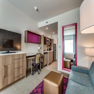 a living room with a desk and a television in a room at Home2 Suites By Hilton Fort Worth Arlington West in Fort Worth