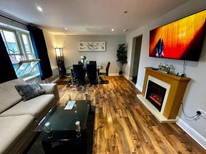 a living room with a couch and a fireplace at Two Bedroom Flat Town Centre Colchester in Colchester