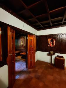 a room with wood paneled walls and a table and a room with a table at Periyaveettil Heritage in Neyyāttinkara +25 photos