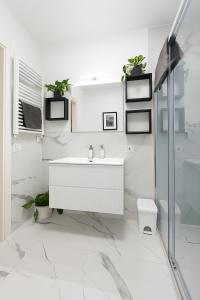 a white bathroom with a sink and a toilet at Luna Luxury Suite in Bergamo +30 photos