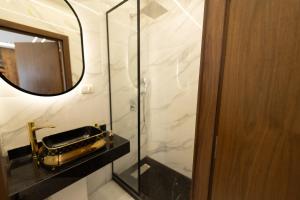 a bathroom with a mirror and a saxophone on a counter at The Muse Luxury View Hotel in Cairo