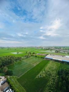 an aerial view of a large green field with a building at Ansh Abode Retreat in Zirakpur