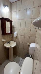 a small bathroom with a toilet and a sink at Hotel Casa Morazán in Granada +40 photos