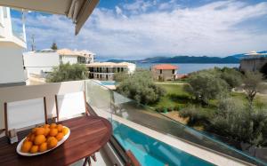 a bowl of oranges sitting on a table on a balcony at Melodia Lefkada apartment 5 in Nikiana