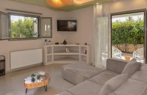 a living room with a couch and a table at Castello Villa in Kástron +33 photos