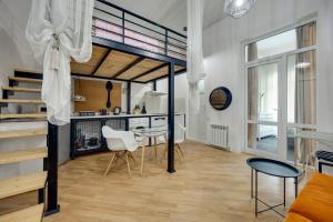 a loft bed in a room with a table and chairs at Freedom Square - Poets' Nest in Tbilisi City