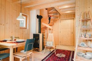 a dining room with a table and a fireplace at Forest Chalet Resort FELIZITAS in San Felice