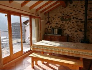 a bedroom with a bed and a large window at Bergerie " Le Cortal " in Nohèdes