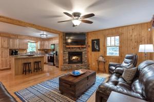 a living room with a couch and a fireplace at 30 Mins to Boone, Fire Pit, Hot Tub, 3 porches, Dogs OK in Brownwood