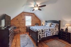 a bedroom with a bed and a ceiling fan at 30 Mins to Boone, Fire Pit, Hot Tub, 3 porches, Dogs OK in Brownwood