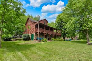 a large house on a lawn with trees at 30 Mins to Boone, Fire Pit, Hot Tub, 3 porches, Dogs OK in Brownwood