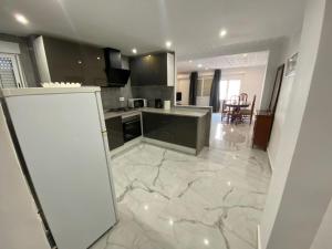 a kitchen with a large marble floor with a counter top at ALLOUCHE Yahia in Torrevieja +7 photos