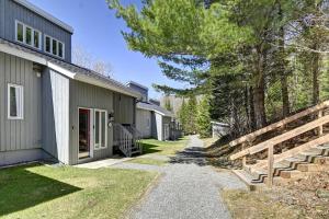 a house with a pathway next to a house at Tremblant Hideaway, Ski & Golf Retreat in Mont-Tremblant