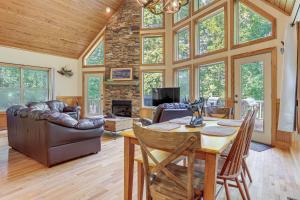 a living room with a table and a couch at Murrayville Lakefront Cabin with Boat Slip and Grill! in Murrayville