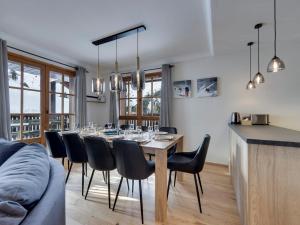 a dining room with a table and chairs at Arc 1950: Appart spacieux 10 pers, skis aux pieds, piscines & spa - FR-1-686-46 in Arc 1950