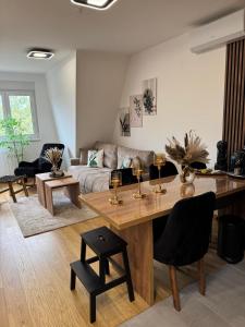 a living room with a table and a couch at WOLF apartman in Divčibare