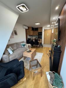 a living room with a couch and a table at WOLF apartman in Divčibare +20 photos