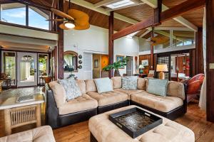 a living room with a couch and a fire place at Orchid Hale in Kailua-Kona