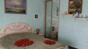 a bedroom with a bed with a red bow on it at Villa Sosnovy Bor in Zatoka