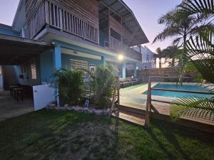 a house with a fence and a swimming pool at Pelican Dock Apartments in Aguada
