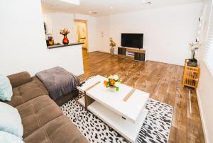 a living room with a couch and a table at Modern 1 Bedroom Apartment Near Hollywood and Koreatown Free Gated Parking Full Kitchen in Los Angeles