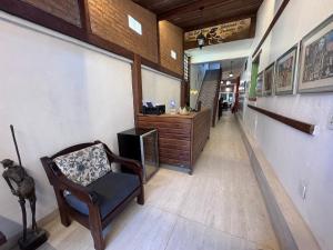 a hallway with a chair and a counter in a store at Pousada Estalagem do Porto in Arraial do Cabo