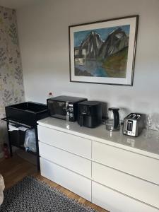 a white dresser with a microwave on top of it at 3 bed self contained part house in Queensferry, Edinburgh in Queensferry +5 photos