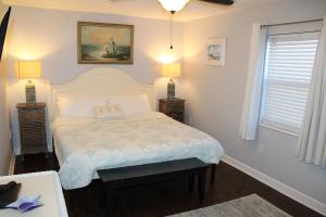 a bedroom with a bed with two night stands and two lamps at Regency Towers W 101 in Pensacola Beach
