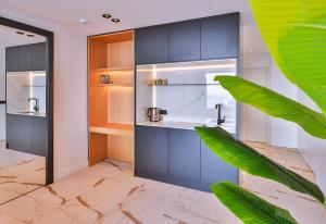 a bathroom with blue cabinets and a green plant at Villa Maresolia in Kas