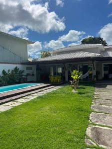 a house with a swimming pool and a yard at CASA OUTEIRO da GLORIA in Porto Seguro