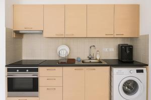 a kitchen with a sink and a dishwasher at Maison Amalthea in Limassol