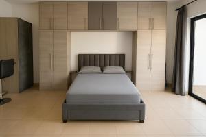 a bedroom with a bed and cabinets at Maison Amalthea in Limassol