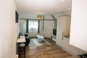 a living room with a couch and a table at Stylish, Spacious 1 Bedroom Apartment, central in Bristol