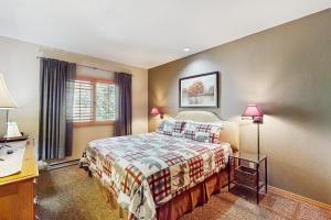 a bedroom with a bed and a desk and two lamps at Cascade 347 in Durango Mountain Resort +69 photos
