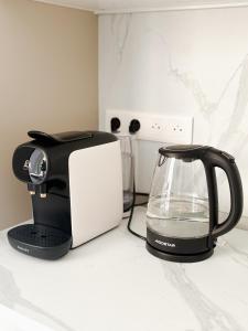 a coffee maker and a toaster on a counter at Nice Center - Spacious Luxury Apartment with Air Conditioning in Nice