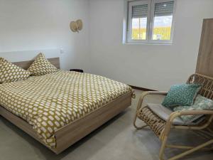 a bedroom with a bed and a chair and a window at Bem estar 3 in Chaves