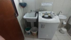 a small bathroom with a toilet and a sink at Casa da praia dois irmãos in Matinhos +33 photos