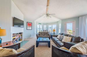 a living room with a couch and a table at Oasis in Poplar Branch