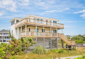 a large house with a deck on top of it at Oasis in Poplar Branch