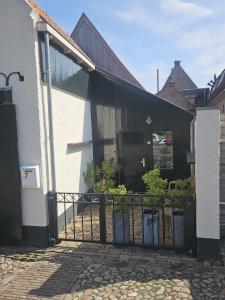 a black gate in front of a house at Appartement "de grote Vesting" Elburg in Elburg