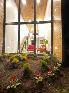 a living room with a red couch and large windows at Alojamiento para 2 con tinaja in Calbuco +12 photos