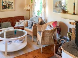 a living room with wicker chairs and a table at 4 person holiday home in Tyresö in Tyresö
