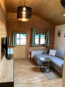 a living room with a couch and a table at Ferienwohnung in Niederhasling in Irschenberg