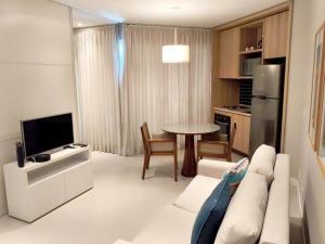a living room with a couch and a table at Estanconfor Santos - vista mar in Santos