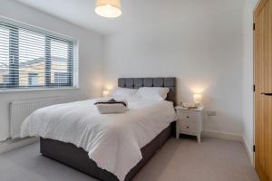 a white bedroom with a large bed and a window at 4 Bed in Brecon oc-m32973 in Brecon