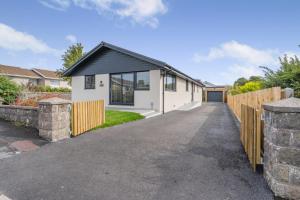a white house with a fence and a driveway at 4 Bed in Brecon oc-m32973 in Brecon