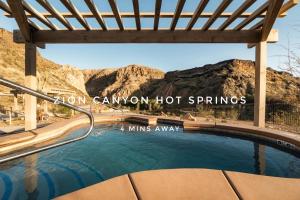a swimming pool with mountains in the background at Newly Remodeled Home Near Zion - Patio & Grill in La Verkin