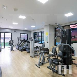 a gym with treadmills and elliptical machines at Flat Higienópolis in São Paulo