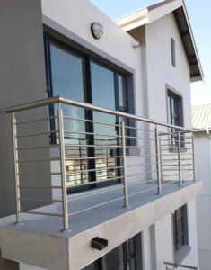 a balcony with a metal railing on a building at CLOSE TO SANDTON and The Airport in Johannesburg